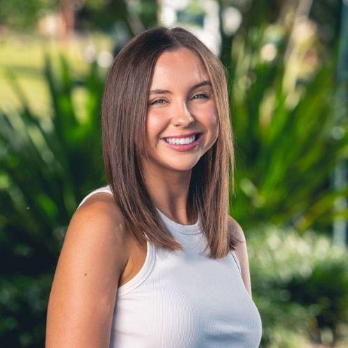 photo of Jasmine mortimer standing in front of a tree. Marketing manager & client services