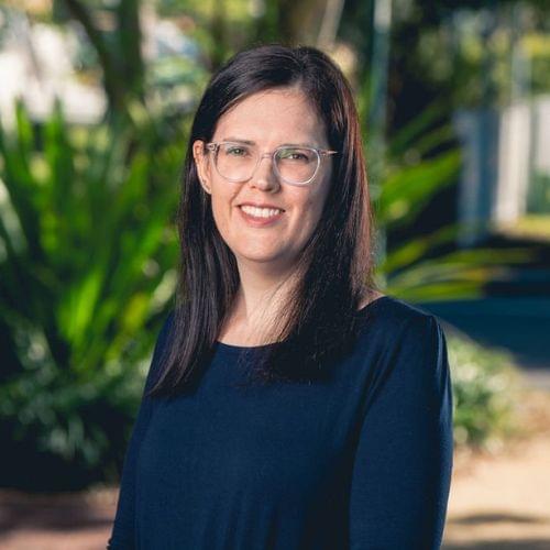 photo of Sarah mazzaglia standing in front of a tree. Client services